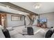 Finished basement with exposed beam, cozy seating, and neutral tones create a perfect area for entertaining or relaxing at 6190 Garrison St, Arvada, CO 80004