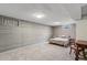 Spacious basement bedroom with gray wood paneling, carpeted floors, and a comfortable bed setup at 6190 Garrison St, Arvada, CO 80004