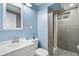 Beautiful bathroom with modern fixtures, sleek tile, and a walk-in shower at 6190 Garrison St, Arvada, CO 80004