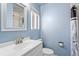 Bathroom with blue walls, white vanity and mirror, and shower and toilet at 6190 Garrison St, Arvada, CO 80004