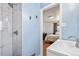Modern bathroom featuring a sleek, tiled shower with updated fixtures and open view to the bedroom at 6190 Garrison St, Arvada, CO 80004