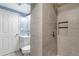 Updated bathroom showcases tiled shower with built-in niche, contemporary vanity, and tiled flooring at 6190 Garrison St, Arvada, CO 80004