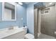 Modern bathroom featuring a sleek vanity, toilet, and tiled shower with glass door at 6190 Garrison St, Arvada, CO 80004