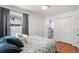 Comfortable bedroom with hardwood floors, neutral decor, and en suite bathroom access at 6190 Garrison St, Arvada, CO 80004