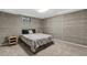 Basement bedroom with carpet, ample lighting, and paneled walls at 6190 Garrison St, Arvada, CO 80004