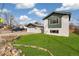 A well-kept front yard of a two-story home featuring green lawn and an rock and plant border at 6190 Garrison St, Arvada, CO 80004