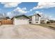Charming home featuring a spacious driveway and attached garage for convenient parking at 6190 Garrison St, Arvada, CO 80004