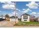 Quaint two-story home with a well-manicured lawn, green trim, and an attached two-car garage at 6190 Garrison St, Arvada, CO 80004