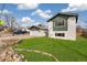 Well-kept two-story home with green trim, lush lawn, and convenient two-car garage at 6190 Garrison St, Arvada, CO 80004