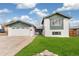 Charming two-story home with a well-maintained lawn and an attached two-car garage at 6190 Garrison St, Arvada, CO 80004