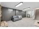 Spacious finished basement living area with stone fireplace and plush carpet; perfect for relaxing at 6190 Garrison St, Arvada, CO 80004