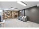 Finished basement living room featuring a stone fireplace, neutral carpet, and comfortable seating at 6190 Garrison St, Arvada, CO 80004