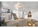 Open concept living room featuring staircase, living area, and a glimpse into the kitchen at 6190 Garrison St, Arvada, CO 80004