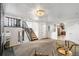 Open-concept living room with staircase, view to the kitchen, and comfortable seating arrangement at 6190 Garrison St, Arvada, CO 80004