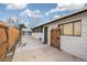 Exterior view of side yard showing concrete walkway, wooden gate, shed and access to the back of the house at 6190 Garrison St, Arvada, CO 80004