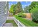 The yard has a lush lawn, wood fence, and mature trees at 8225 W 67Th Pl, Arvada, CO 80004