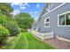 Lush green backyard with a white picket fence provides privacy and charm for relaxation and outdoor enjoyment, adding to the home's appeal at 8225 W 67Th Pl, Arvada, CO 80004