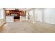Large open basement area with home theater, bar, and neutral carpet at 8225 W 67Th Pl, Arvada, CO 80004