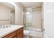 Well-lit bathroom featuring a vanity, toilet, and shower at 8225 W 67Th Pl, Arvada, CO 80004
