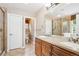 Bathroom featuring double sinks, a vanity, shower, and toilet at 8225 W 67Th Pl, Arvada, CO 80004