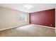 Bright bedroom has neutral carpet, a window, and freshly painted walls at 8225 W 67Th Pl, Arvada, CO 80004