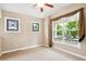 Bright bedroom with large windows showcasing neighborhood views and letting in natural light at 8225 W 67Th Pl, Arvada, CO 80004