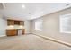 Spacious bonus room complete with kitchenette, cabinets, and mini fridge at 8225 W 67Th Pl, Arvada, CO 80004