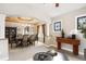 Open dining room with elegant chandelier, decorative ceiling, and stylish furnishings create a welcoming atmosphere at 8225 W 67Th Pl, Arvada, CO 80004
