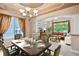 Elegant dining area with set table and open view to the living room at 8225 W 67Th Pl, Arvada, CO 80004