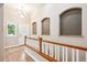 Bright entryway with hardwood floors, decorative wall cutouts, and a chandelier at 8225 W 67Th Pl, Arvada, CO 80004