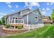 Exterior shot of the home with a deck, patio, and blue siding at 8225 W 67Th Pl, Arvada, CO 80004