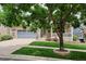 Charming brick home with a well-manicured lawn, a covered porch, and a two-car garage at 8225 W 67Th Pl, Arvada, CO 80004