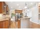 Well-equipped kitchen featuring granite countertops, stainless steel appliances, and wood floors at 8225 W 67Th Pl, Arvada, CO 80004