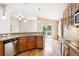 Stylish kitchen features granite countertops, wooden cabinets, and stainless steel appliances at 8225 W 67Th Pl, Arvada, CO 80004