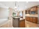 Open kitchen with granite counters, stainless appliances, and adjacent dining space at 8225 W 67Th Pl, Arvada, CO 80004