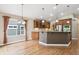 Bright kitchen with granite counters, stainless appliances, and adjacent dining space at 8225 W 67Th Pl, Arvada, CO 80004