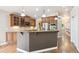 Spacious kitchen featuring granite countertops, stainless steel appliances, and wood floors at 8225 W 67Th Pl, Arvada, CO 80004