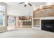 Open living area with fireplace, kitchen, and dining area at 8225 W 67Th Pl, Arvada, CO 80004