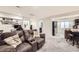 Spacious basement featuring a comfortable seating area, television, and bar with kitchen amenities at 334 Octillo St, Brighton, CO 80601