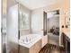 A bathtub and open doorway leading into a bedroom give depth and utility to this bathroom at 334 Octillo St, Brighton, CO 80601