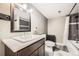 Contemporary bathroom with dark vanity, modern fixtures, and shower with patterned backsplash tiles at 334 Octillo St, Brighton, CO 80601