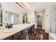 Bathroom featuring double sinks, a large mirror with vanity lighting, and modern vanities at 334 Octillo St, Brighton, CO 80601
