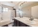 Clean bathroom with a double vanity and a shower-tub combination at 334 Octillo St, Brighton, CO 80601