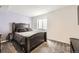 A bedroom with carpet, large bed, and a purple accent wall at 334 Octillo St, Brighton, CO 80601