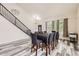 Dining room adjacent to staircase features stylish flooring and decor at 334 Octillo St, Brighton, CO 80601