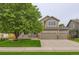 Charming two-story home featuring a three-car garage, well-manicured lawn, and inviting curb appeal at 334 Octillo St, Brighton, CO 80601