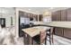 Well-equipped kitchen boasts a breakfast bar, stainless steel refrigerator, and modern cabinetry at 334 Octillo St, Brighton, CO 80601
