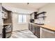 Basement kitchen featuring modern appliances, light wood countertops, and ample cabinet storage at 334 Octillo St, Brighton, CO 80601