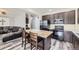 This kitchen features a breakfast bar, stainless steel appliances, and modern cabinetry at 334 Octillo St, Brighton, CO 80601