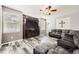 Comfortable living room features a ceiling fan, neutral paint, and stylish flooring at 334 Octillo St, Brighton, CO 80601